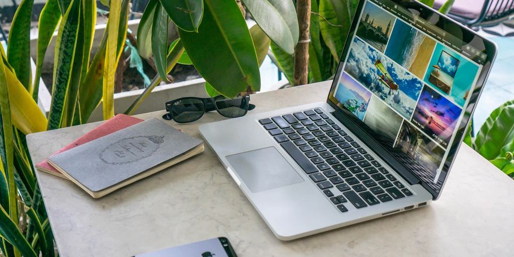 digital nomad working on laptop at beach