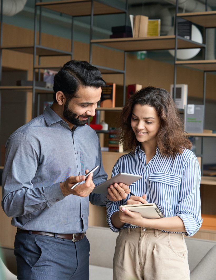 diverse friendly coworkers talking using digital tablet in office jpg